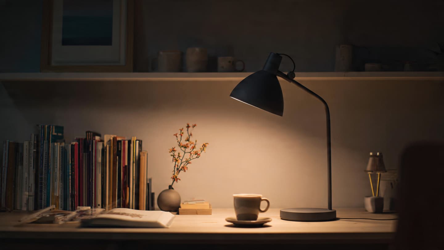 Desk setup with a dedicated adjustable desk lamp providing focused task lighting