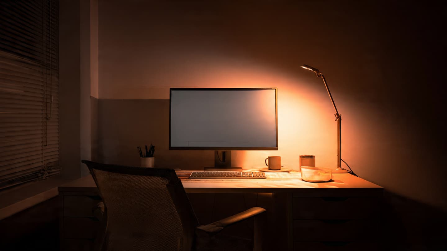Desk with harsh lighting and screen glare