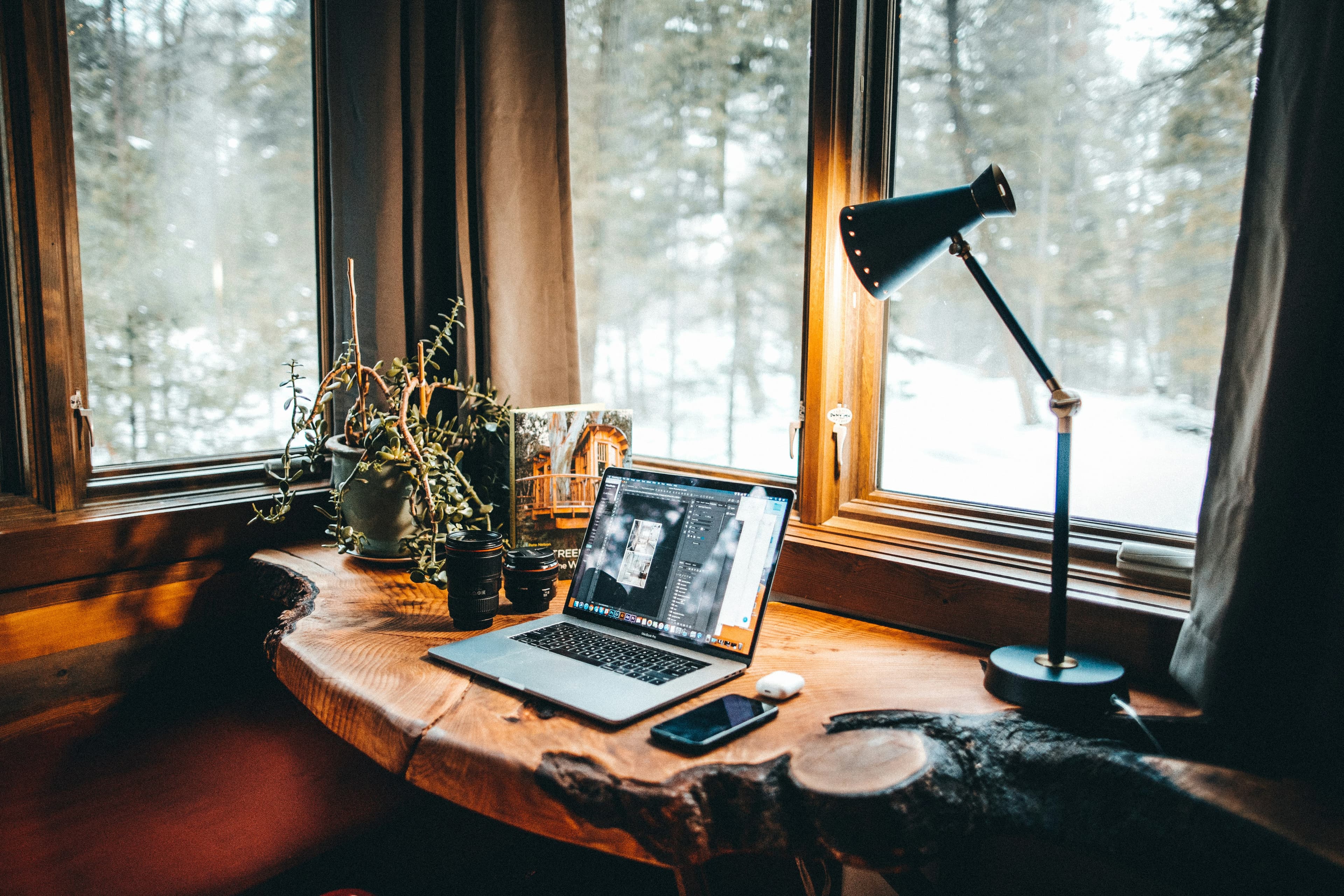 Warm wood and black desk setup with ambient lighting