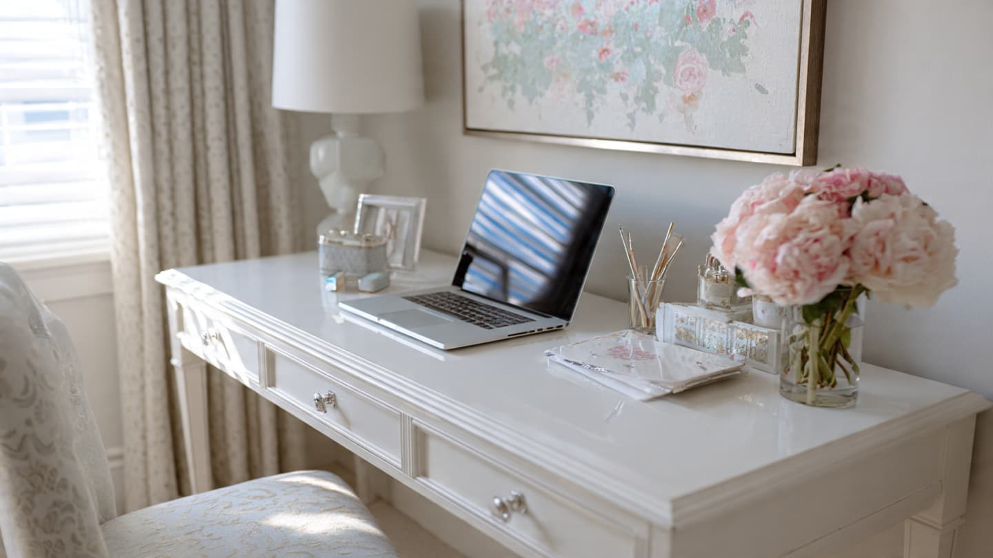 White minimalist desk with subtle personal touches